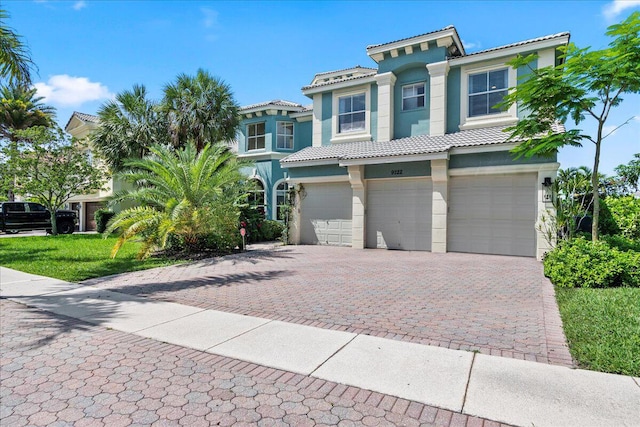 9222 Delemar Ct, Wellington, FL 33414 - view of front of house with stucco siding, a garage, a tiled roof, and driveway