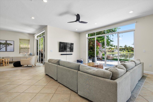 9222 Delemar Ct, Wellington, FL 33414 - living room featuring light tile patterned floors, recessed lighting, ceiling fan, and a textured ceiling
