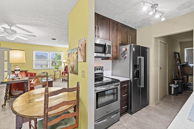 849 SE Celtic Ave, Port Saint Lucie, FL 34983 - kitchen with appliances with stainless steel finishes, a textured ceiling, a ceiling fan, dark brown cabinets, and light countertops