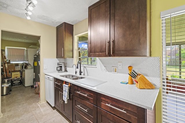 849 SE Celtic Ave, Port Saint Lucie, FL 34983 - kitchen with white dishwasher, tasteful backsplash, light tile patterned flooring, a textured ceiling, and track lighting