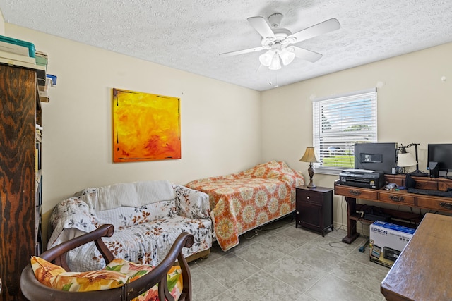 849 SE Celtic Ave, Port Saint Lucie, FL 34983 - bedroom featuring a textured ceiling, a ceiling fan, light tile patterned floors, and a desk