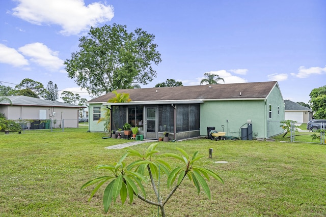 849 SE Celtic Ave, Port Saint Lucie, FL 34983 - back of property with a sunroom, a fenced backyard, a gate, and stucco siding