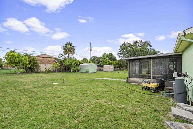 849 SE Celtic Ave, Port Saint Lucie, FL 34983 - view of yard with a storage unit and a sunroom