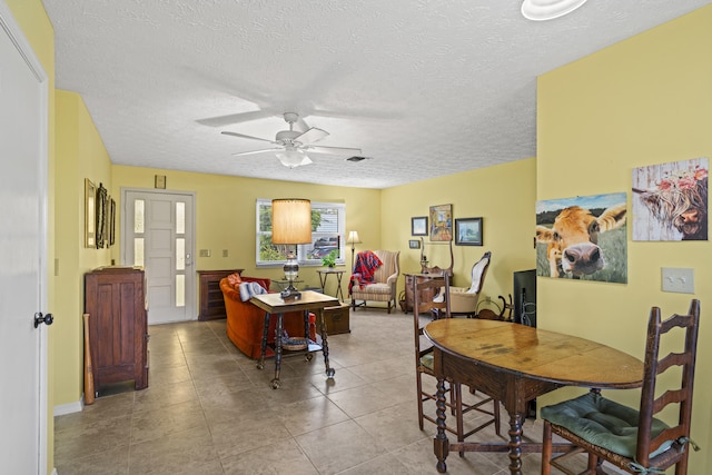 849 SE Celtic Ave, Port Saint Lucie, FL 34983 - dining space with a ceiling fan, a textured ceiling, and tile patterned floors