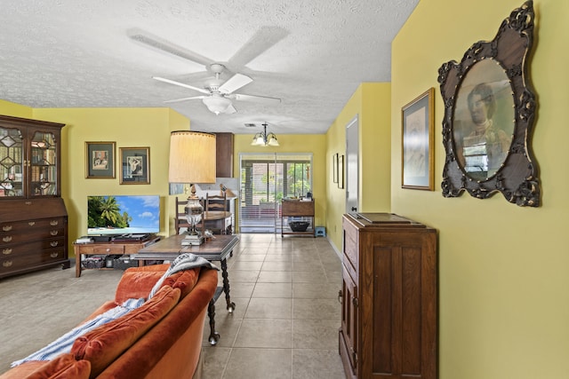 849 SE Celtic Ave, Port Saint Lucie, FL 34983 - living room featuring a textured ceiling, ceiling fan, and tile patterned floors