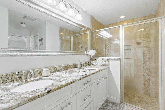 5533 NW Cordrey St, Port Saint Lucie, FL 34986 - full bathroom with double vanity, a stall shower, a textured ceiling, and tile patterned floors