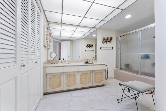 4100 Galt Ocean Dr Unit 302, Fort Lauderdale, FL 33308 - bathroom with tile patterned floors, a shower with shower door, double vanity, a closet, and recessed lighting