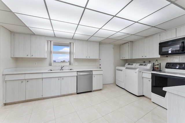 4100 Galt Ocean Dr Unit 302, Fort Lauderdale, FL 33308 - kitchen featuring dishwasher, black microwave, white electric stove, washer and dryer, and light countertops