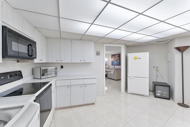 4100 Galt Ocean Dr Unit 302, Fort Lauderdale, FL 33308 - kitchen featuring freestanding refrigerator, black microwave, stainless steel microwave, range with electric stovetop, and light countertops