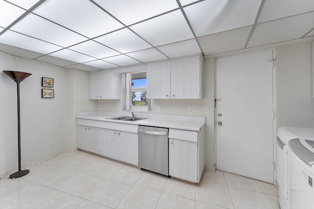 4100 Galt Ocean Dr Unit 302, Fort Lauderdale, FL 33308 - kitchen with stainless steel dishwasher, washing machine and dryer, light countertops, light tile patterned floors, and a paneled ceiling