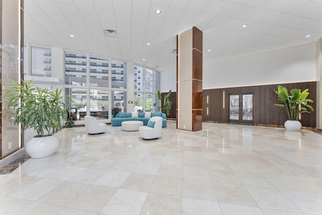 4100 Galt Ocean Dr Unit 302, Fort Lauderdale, FL 33308 - community lobby featuring wood walls, recessed lighting, and a high ceiling