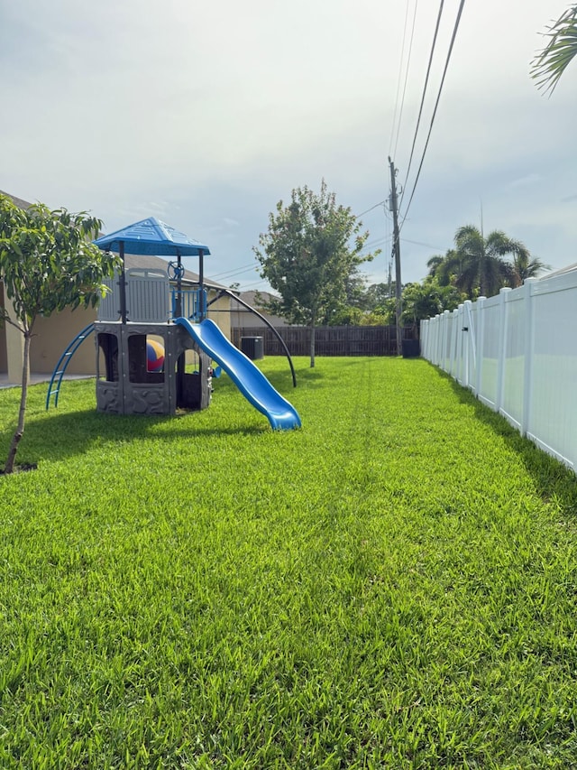 2313 SW Neal Rd, Port Saint Lucie, FL 34953 - fenced backyard featuring a playground