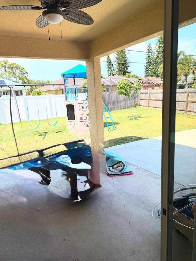 2313 SW Neal Rd, Port Saint Lucie, FL 34953 - fenced backyard with a playground, a patio, and ceiling fan