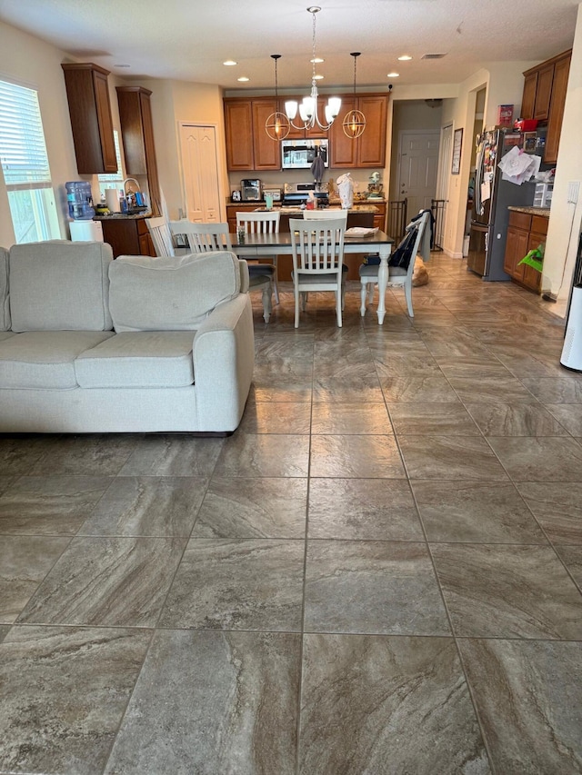 2313 SW Neal Rd, Port Saint Lucie, FL 34953 - living room with a chandelier and recessed lighting