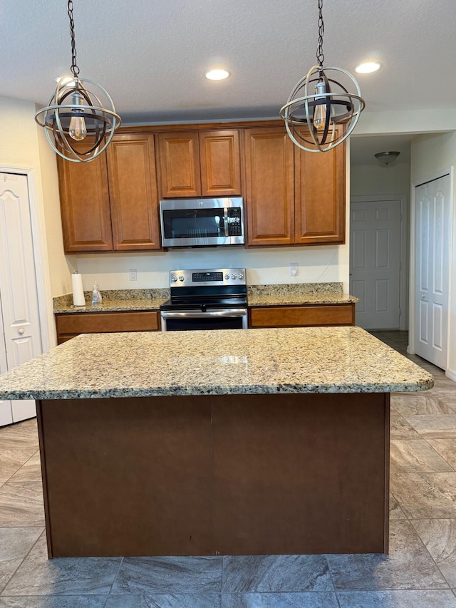 2313 SW Neal Rd, Port Saint Lucie, FL 34953 - kitchen featuring stainless steel appliances, a chandelier, brown cabinetry, decorative light fixtures, and light stone counters