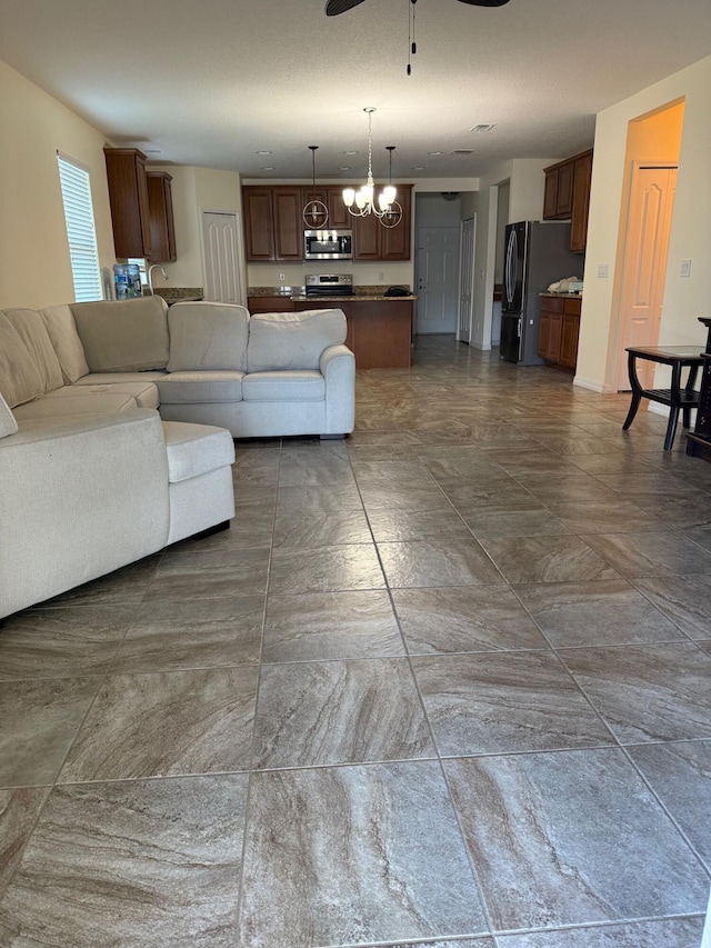 2313 SW Neal Rd, Port Saint Lucie, FL 34953 - living room with a ceiling fan and a chandelier