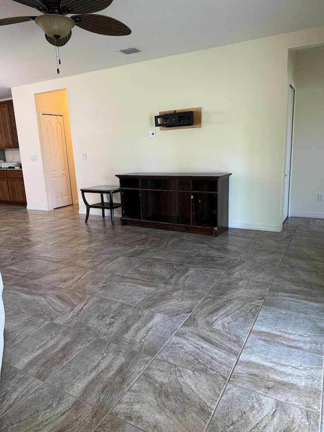 2313 SW Neal Rd, Port Saint Lucie, FL 34953 - unfurnished living room with a ceiling fan and baseboards