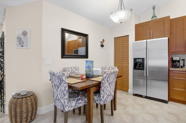 9927 Boca Gardens Trl Unit A, Boca Raton, FL 33496 - dining space with lofted ceiling and light tile patterned floors
