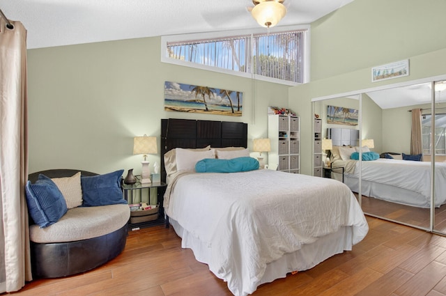 9927 Boca Gardens Trl Unit A, Boca Raton, FL 33496 - bedroom with wood finished floors, high vaulted ceiling, and a closet