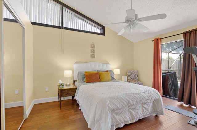 9927 Boca Gardens Trl Unit A, Boca Raton, FL 33496 - bedroom featuring lofted ceiling, wood finished floors, a textured ceiling, access to exterior, and a ceiling fan