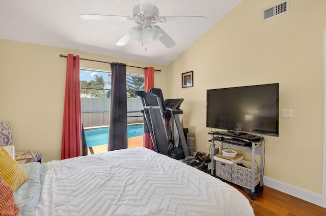 9927 Boca Gardens Trl Unit A, Boca Raton, FL 33496 - bedroom featuring vaulted ceiling, access to exterior, wood finished floors, a textured ceiling, and ceiling fan