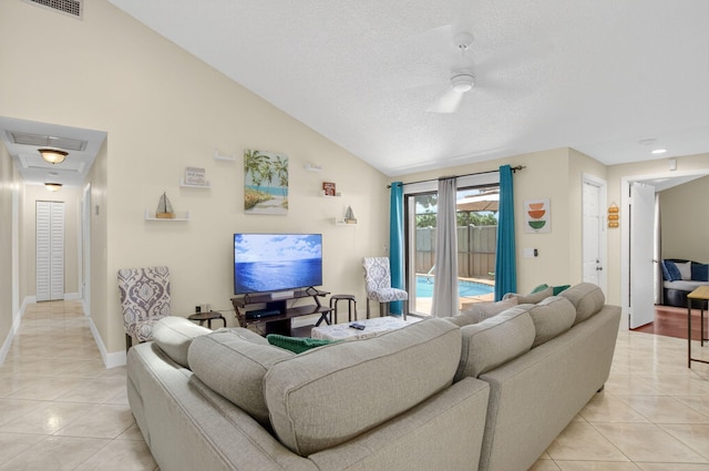 9927 Boca Gardens Trl Unit A, Boca Raton, FL 33496 - living area featuring light tile patterned flooring, vaulted ceiling, and a textured ceiling
