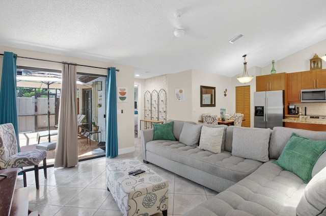9927 Boca Gardens Trl Unit A, Boca Raton, FL 33496 - living room featuring light tile patterned floors, vaulted ceiling, and a textured ceiling