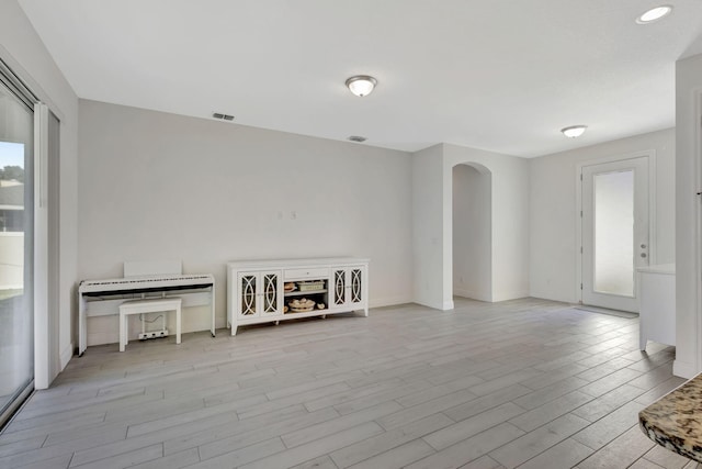 774 SE Ablett Ln, Port Saint Lucie, FL 34984 - unfurnished room featuring arched walkways and light wood-style floors