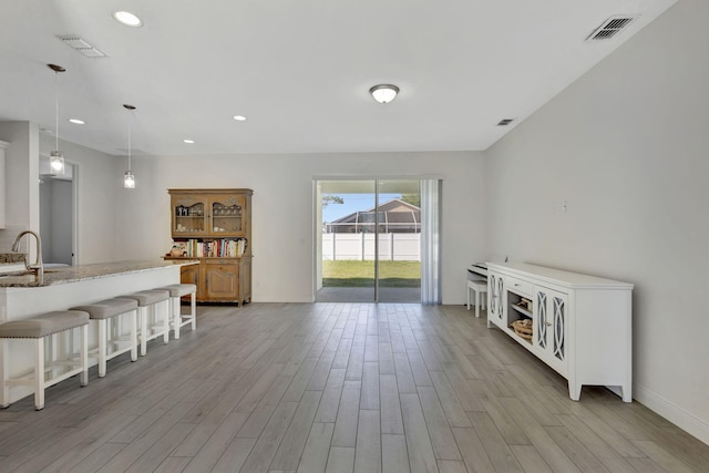 774 SE Ablett Ln, Port Saint Lucie, FL 34984 - living room with light wood-style flooring and recessed lighting