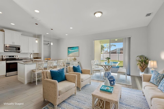 774 SE Ablett Ln, Port Saint Lucie, FL 34984 - living room featuring light wood-style floors, recessed lighting, and ceiling fan