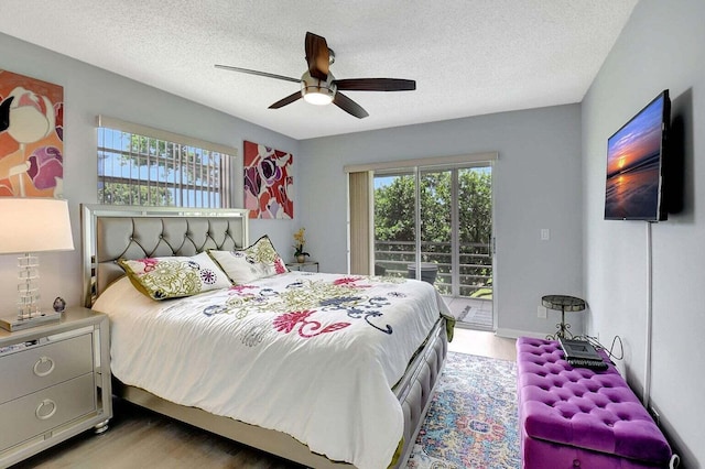 74 Normandy Unit B, Delray Beach, FL 33484 - bedroom with access to outside, light wood-style flooring, multiple windows, a textured ceiling, and ceiling fan