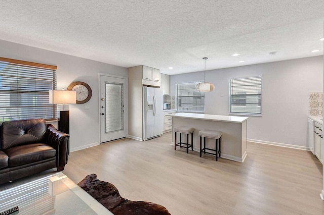 74 Normandy Unit B, Delray Beach, FL 33484 - living area with light wood finished floors, a textured ceiling, and recessed lighting