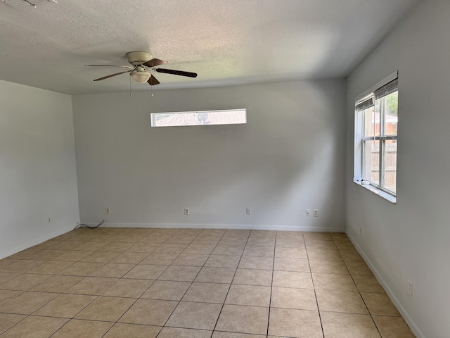 1965 SW Bellevue Ave, Port Saint Lucie, FL 34953 - empty room with ceiling fan, a textured ceiling, and light tile patterned floors
