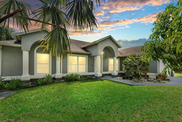 1901 SW Diamond St, Port Saint Lucie, FL 34953 - view of front of property featuring stucco siding, a yard, and a shingled roof