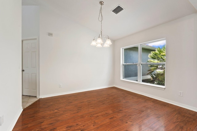 1901 SW Diamond St, Port Saint Lucie, FL 34953 - unfurnished room with wood finished floors, vaulted ceiling, and a chandelier