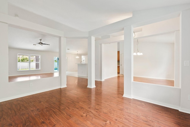 1901 SW Diamond St, Port Saint Lucie, FL 34953 - unfurnished living room with a chandelier, wood finished floors, and a ceiling fan