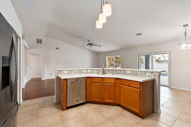 1901 SW Diamond St, Port Saint Lucie, FL 34953 - kitchen with appliances with stainless steel finishes, light countertops, brown cabinets, ceiling fan, and vaulted ceiling