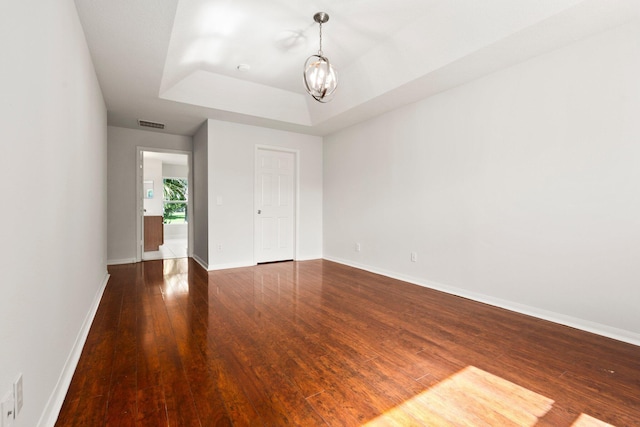 1901 SW Diamond St, Port Saint Lucie, FL 34953 - empty room featuring a tray ceiling and wood finished floors