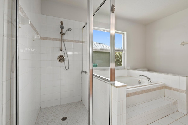 1901 SW Diamond St, Port Saint Lucie, FL 34953 - bathroom with a shower stall, a garden tub, and tile patterned floors