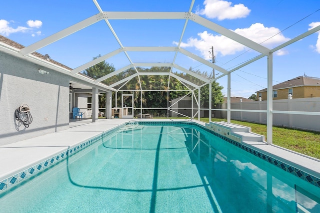 1901 SW Diamond St, Port Saint Lucie, FL 34953 - view of swimming pool featuring a patio area, a fenced backyard, glass enclosure, and a shed