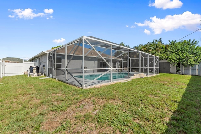 1901 SW Diamond St, Port Saint Lucie, FL 34953 - back of property featuring a fenced backyard, an outdoor pool, a storage shed, and glass enclosure
