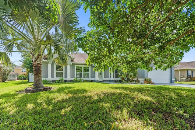 1901 SW Diamond St, Port Saint Lucie, FL 34953 - view of property hidden behind natural elements featuring concrete driveway, a garage, a front yard, and stucco siding