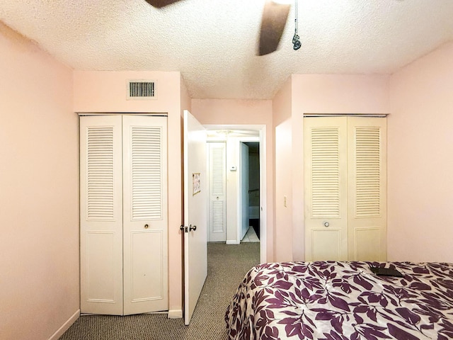 3658 Alder Dr Unit D1, West Palm Beach, FL 33417 - carpeted bedroom with a textured ceiling, multiple closets, and a ceiling fan