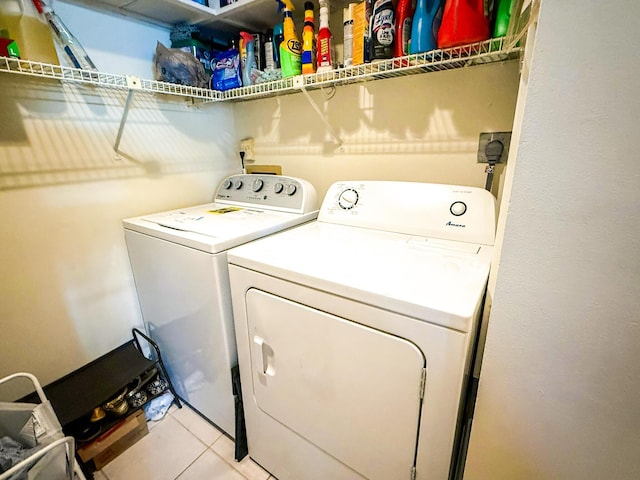 3658 Alder Dr Unit D1, West Palm Beach, FL 33417 - washroom with independent washer and dryer and light tile patterned floors