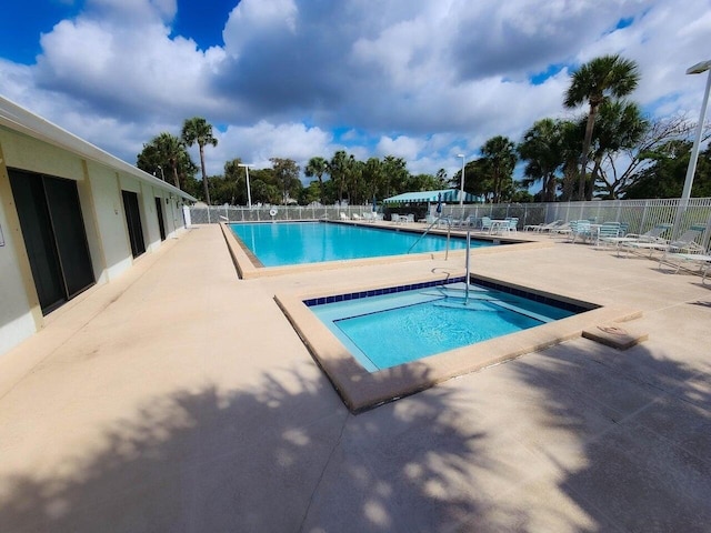 3658 Alder Dr Unit D1, West Palm Beach, FL 33417 - community pool with a patio area and a hot tub