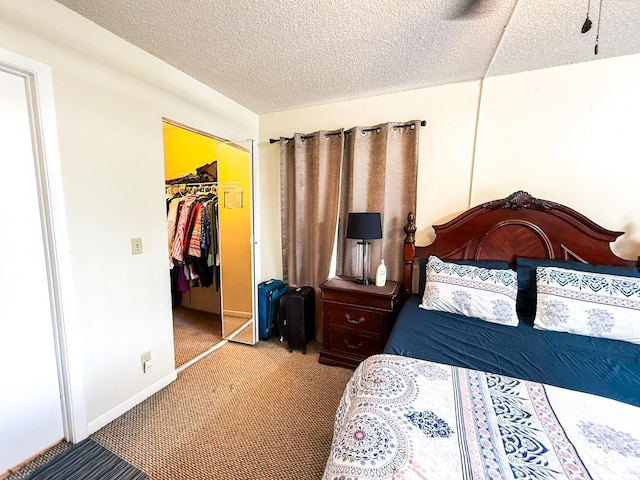 3658 Alder Dr Unit D1, West Palm Beach, FL 33417 - carpeted bedroom with a walk in closet, a textured ceiling, and a closet