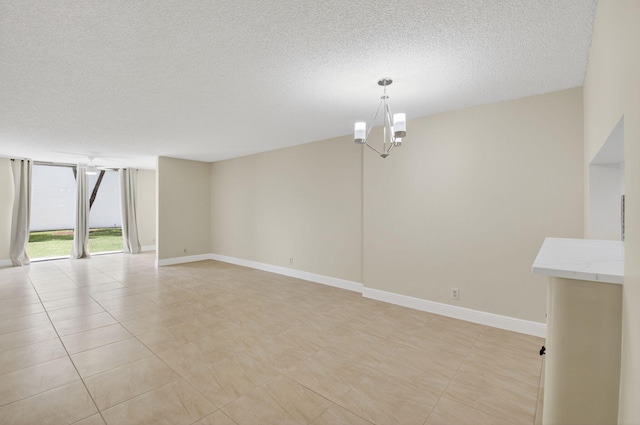 5574 Witney Dr Unit 104, Delray Beach, FL 33484 - spare room featuring a textured ceiling and a chandelier