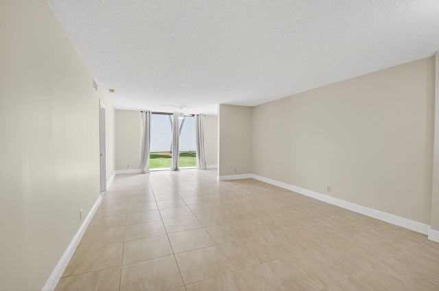 5574 Witney Dr Unit 104, Delray Beach, FL 33484 - empty room with a textured ceiling and light tile patterned floors