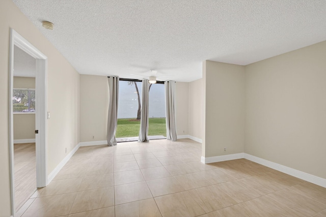 5574 Witney Dr Unit 104, Delray Beach, FL 33484 - spare room with a smoke detector, a textured ceiling, and light tile patterned floors