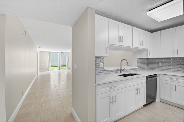 5574 Witney Dr Unit 104, Delray Beach, FL 33484 - kitchen with dishwasher, light tile patterned flooring, decorative backsplash, light countertops, and a textured ceiling
